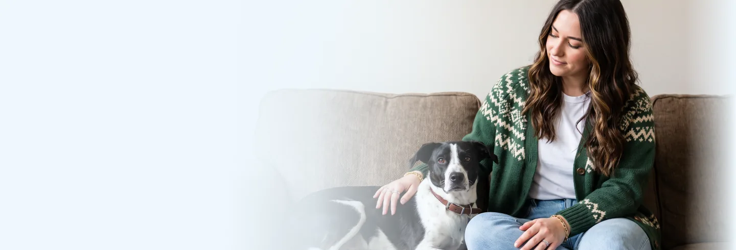 A foster caregiver sitting with her rescue dog